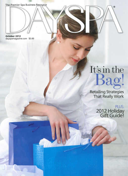 Day Spa October 2012 magazine cover featuring a woman in a white button-down shirt opening blue shopping bags, with the headline 'It's in the Bag! Retailing Strategies That Really Work' and 'PLUS: 2012 Holiday Gift Guide!'.