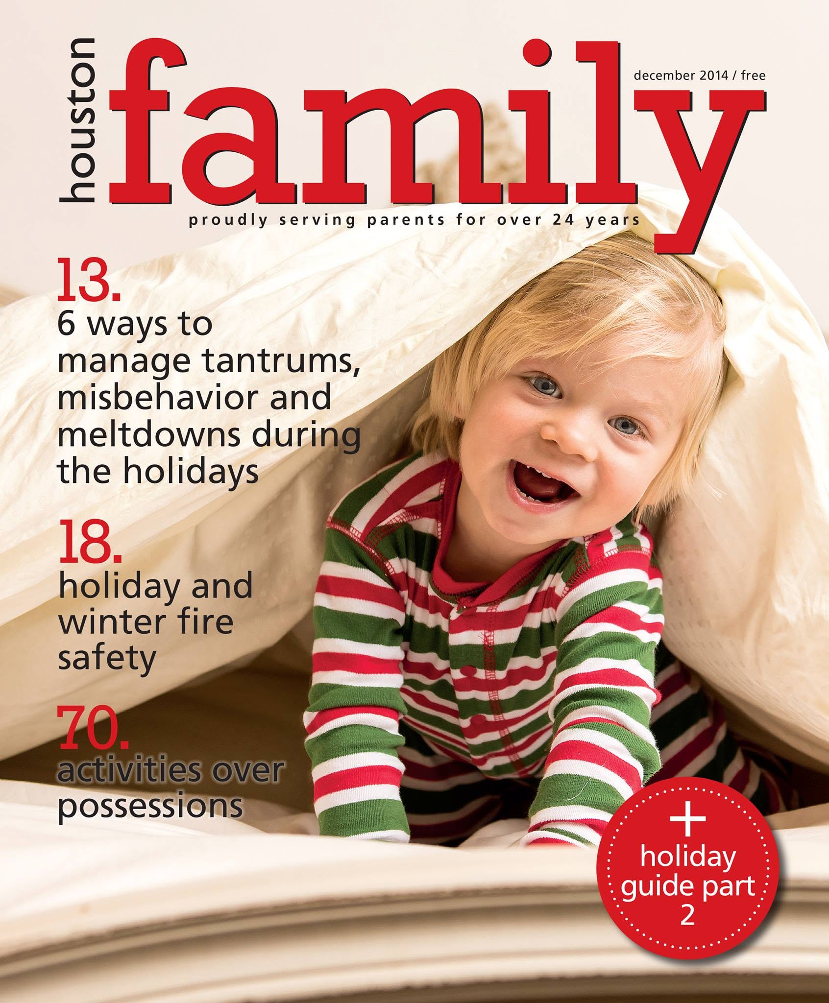 December 2014 issue of Houston Family magazine cover, featuring a young child smiling while tucked under a beige blanket. The title 'houston family' is displayed in large red letters at the top, with article titles listed on the left and a red circular badge reading 'holiday guide part 2' in the bottom right corner.