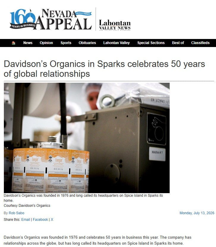 A newspaper article page from the Nevada Appeal and Lahontan Valley News featuring a photo of Davidson's Organics products on a production line.