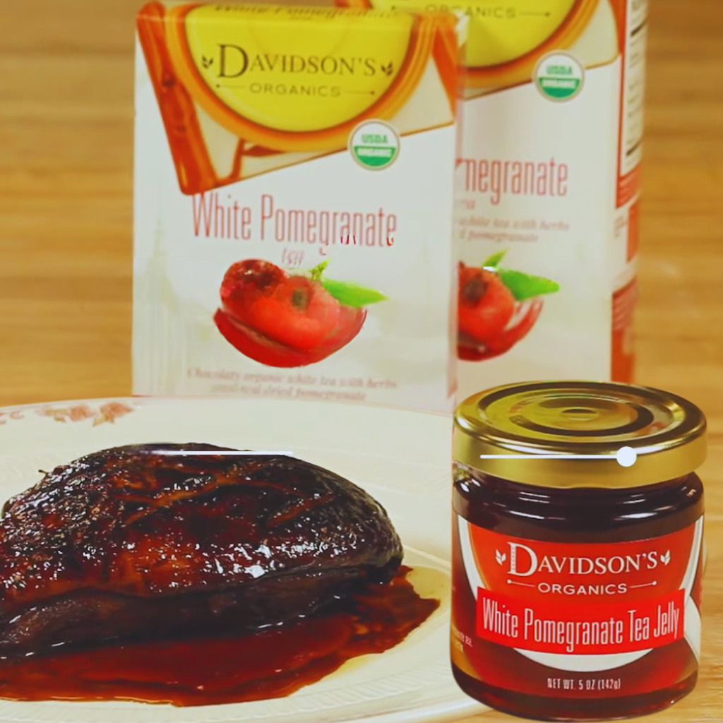 DAVIDSON'S Organics White Pomegranate tea jelly jar with packaging on a wooden surface