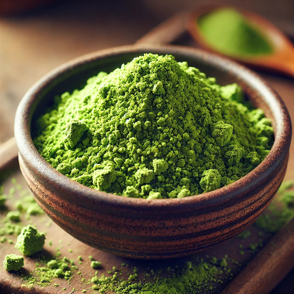 Green powder in a wooden bowl on a wooden surface