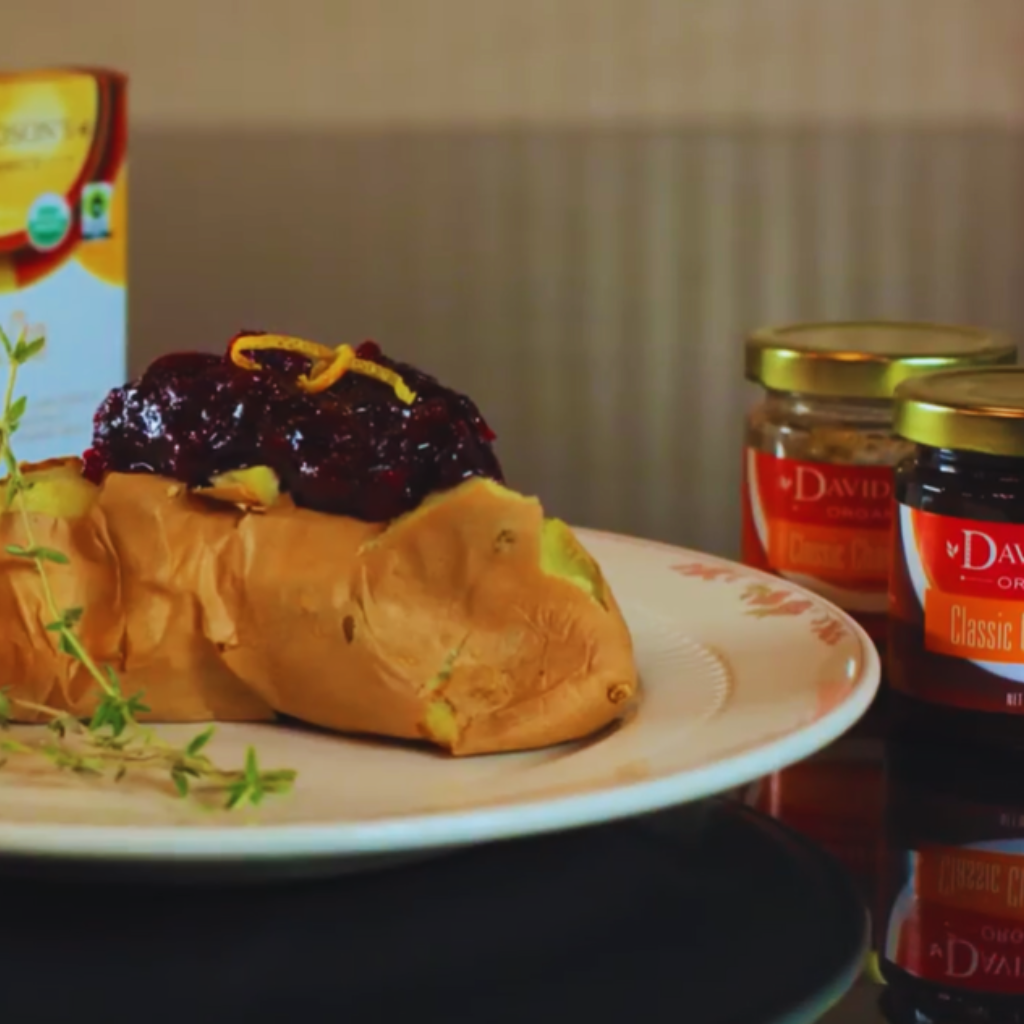 Pastry with jam on a plate next to jars of jam