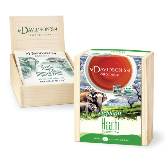 Davidson's Organics tea packaging with a wooden display stand on a white background