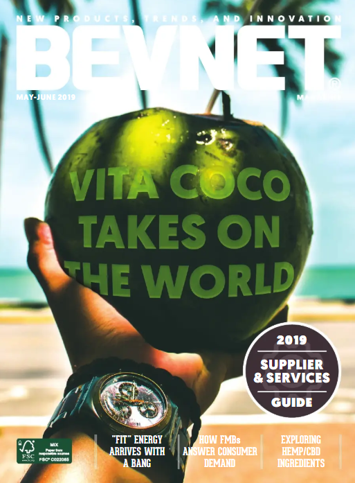 Magazine cover featuring a hand holding a green fruit with text about 'Vita Coco' on a beach background.