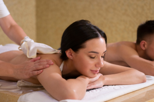 A person receives a relaxing back massage at a spa.