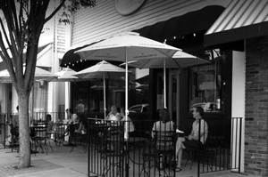 Outdoor restaurant patio with tables, chairs, and umbrellas.