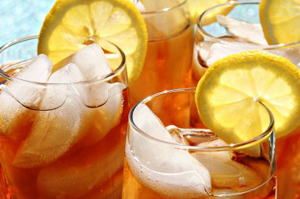 Close-up of iced tea glasses with lemon slices and ice cubes.